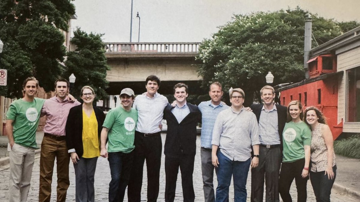The early Shipt team standing together on a cobblestone street in Birmingham, Alabama