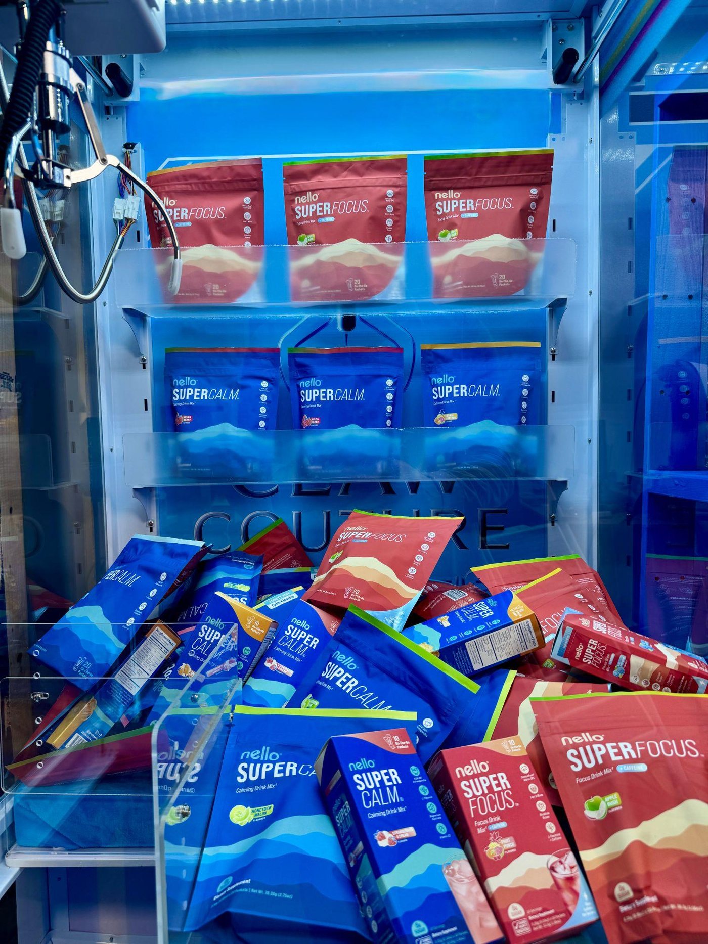Inside the claw machine, product bags under the claw